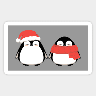 Couple of cute penguins, friends in winter Christmas red hat and scarf. Magnet